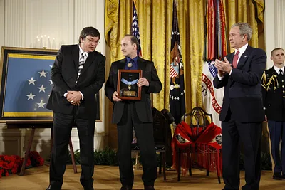President George W. Bush Applauds After Presenting the Medal of Honor Posthumously to Family Members of U.S. Army MSG Woodrow Wilson Keeble