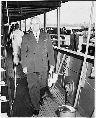 Photograph of President Truman walking aft on his yacht, the U.S.S. WILLIAMSBURG