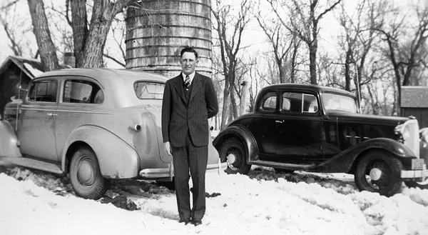 Man in Suit with Vintage Cars, Cedar Falls, 1940