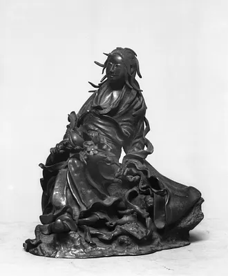 Seated woman with peach branch