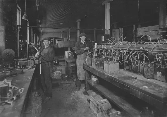 Ernie Coonradt working to charge generator batteries, 1930