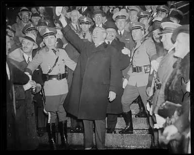 James M. Curley waving hat to the crowd