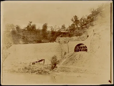 Construction of stone dam and bridge near river