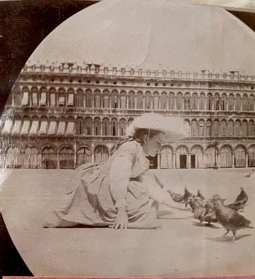 Unidentified girl feeding pigeons