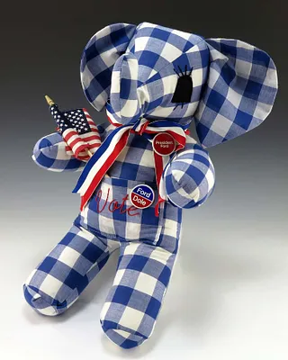 Blue and White Gingham Stuffed Elephant With the Word “Vote” Embroidered in Red
