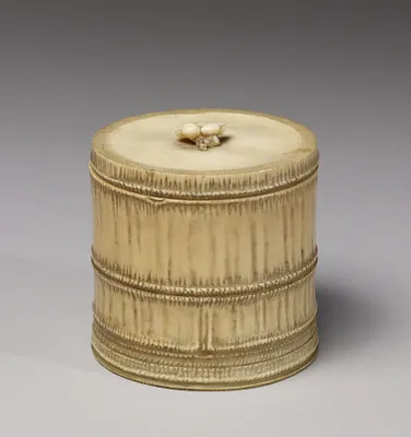 Container in the shape of a bamboo section with a plum blossom knop on lid
