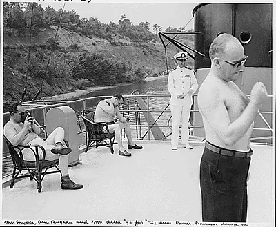 Photograph of members of President Truman's party enjoying the sun on the flying bridge of the President's yacht, the U.S.S. WILLIAMSBURG, during their vacation cruise to Rhode Island and Bermuda: (left to right) General Harry Vaughan, Military Aide to the President; George Allen, Director of the Reconstruction Finance Corporation; Commander Emerson, the ship's doctor; and Treasury Secretary John Snyder