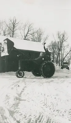 Lee Bull celebrating on his new tractor, 1950