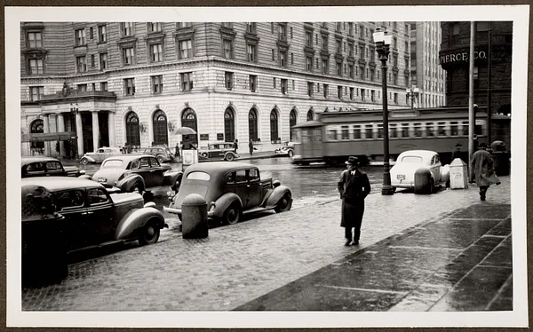View of surface car in Copley Square from front of Boston Public Library