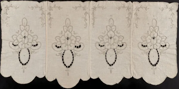 Embroidered scalloped textile with cut outs