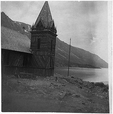Lake Bennet on W.P. and Y.R.R. Old Church on left, mountains in the background.