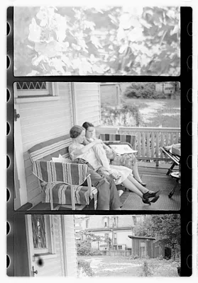 People, including Maude Sanromá, seated on a porch
