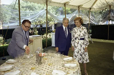 First Lady Betty Ford with Two Unidentified Men Looking at Table Settings and Decorations in the Tent on the South Lawn of the White House during Preparations for a State Dinner Honoring Chancellor Helmut Schmidt of the Federal Republic of Germany