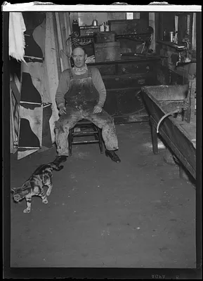 Man in dark room with cat