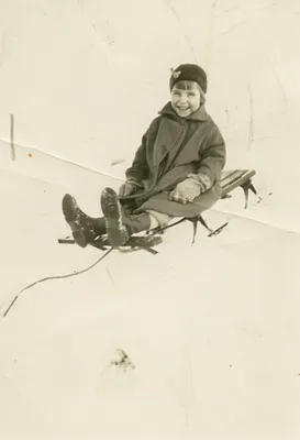 Diane Holland on the wooden sled, 1960