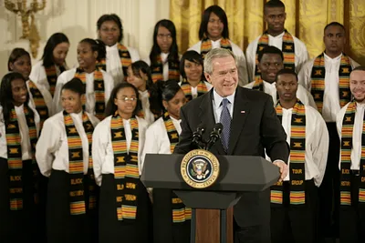 President George W. Bush, Standing with Members of the Jackson High School Black History Tour Group of Jackson, Michigan, Welcomes Guests to the East Room of the White House During the Celebration of African American History Month