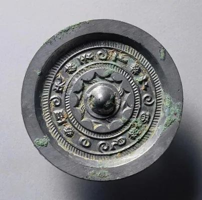 Mirror with Concentric Circles and Linked Arcs