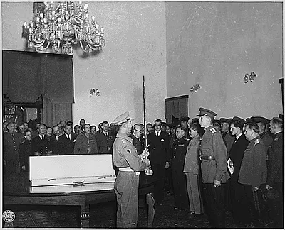 The Prime Minister in behalf of King George VI of Great Britain, presents The Sword of Stalingrad to Stalin, for the citizens of Stalingrad, in the board room of the Russian Embacy at Teheram.