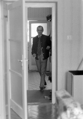 Man Walking Through Open Doorway