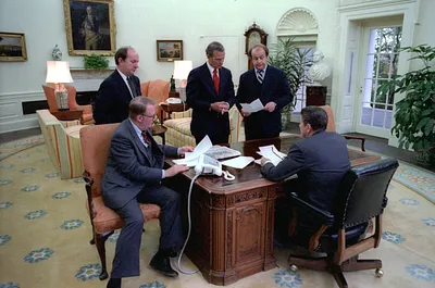 President Reagan Holds an Oval Office Staff Meeting on His First Full Day in Office with Michael Deaver, Ed Meese, James Baker III, and James Brady