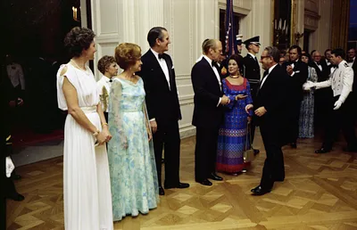 Prime Minister Malcolm Fraser of Australia, First Lady Betty Ford, and Mrs. Tamara Fraser Standing in the Receiving Line While President Gerald R. Ford and Chief of Protocol Shirley Temple Black Speak with Secretary of State Henry Kissinger at a State Dinner Honoring Prime Minister Fraser