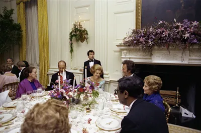 First Lady Betty Ford, President Valery Giscard d'Estaing of France, Choreographer Martha Graham, Actor Clint Eastwood, Fashion Designer Adele Simpson, and Jazz Pianist Earl Hines Seated in the State Dining Room at a State Dinner Honoring President Giscard d'Estaing