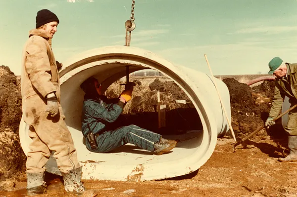 Workers Installing Concrete Pipe, 1980