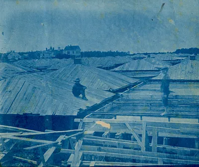 Two boys on wooden rooftops of salt vats, South Yarmouth, Mass.
