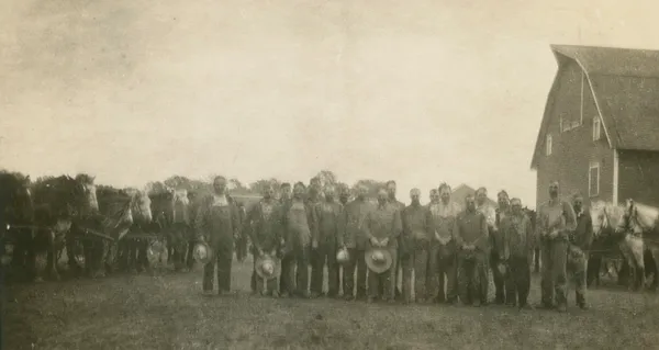 Bull family and men preparing for harvest, Dysart, 1930