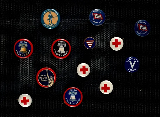 Collection of Liberty Loan buttons, pins and coins