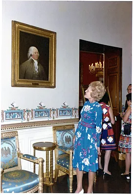 Pat Nixon Standing by a Portrait of John Adams