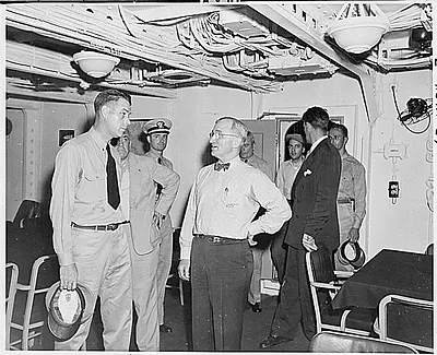 President Harry S. Truman tours the U. S. S. Augusta, the ship that will take him to Europe to attend the Potsdam Conference in Germany. He and Commander C. L. Freeman are in the wardroom.