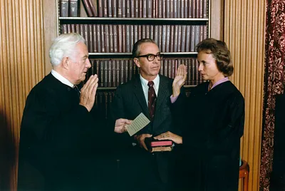 Photograph of Sandra Day O'Connor Being Sworn in a Supreme Court Justice by Chief Justice Warren Burger, Her Husband John O'Connor Looks On