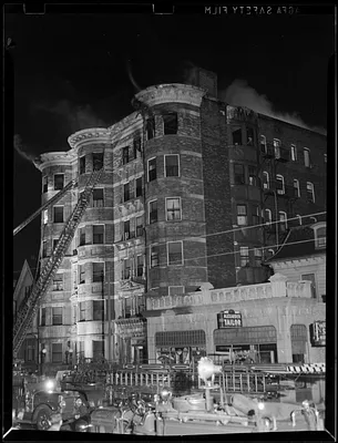 Ladders and Ladder 4 Cambridge Fire Engine outside a building on fire next to Alexander Tailor