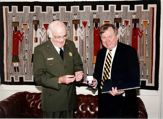 Historic American Building Survey/Historic American Engineering Record (HABS/HAER) Chief Dr. Robert J. Kapsch receiving Meritorious Service Medal from National Park Service Director Roger Kennedy, 1993.