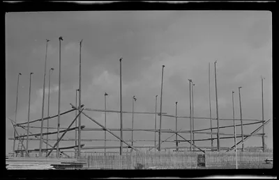 Constructing a new building at College. Flags on top of poles are to ward off evil spirits.