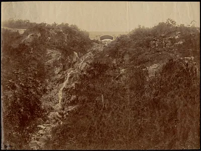 Waterfall and stone arch bridge