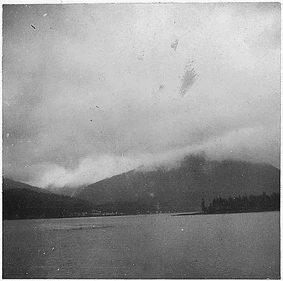 View of a river and mountain; city in background.