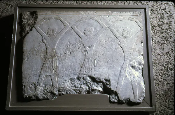 Relief Fragment with a Squatting Male Figure and Two Female Figures