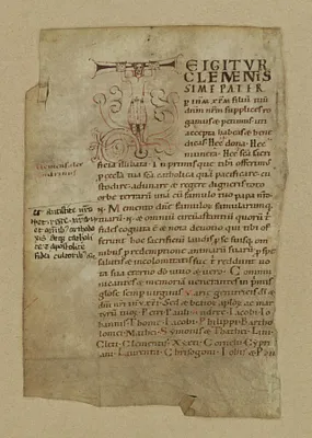 Initial ""T"" (Te igitur) supported by a skirt-clad man