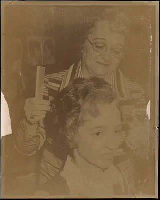 One woman doing another woman's hair