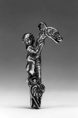 Silver pendant with boy riding a dragon