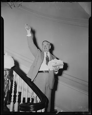 James M. Curley waves from the staircase