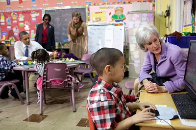 President Barack Obama and others working with children together in a classroom