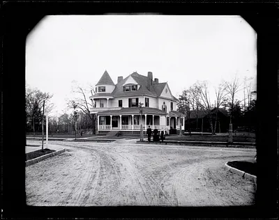 Large Queen Anne style house with family