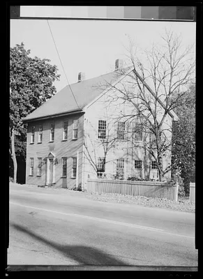 Unidentified house by paved road