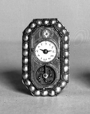 Watch set in face of a brooch