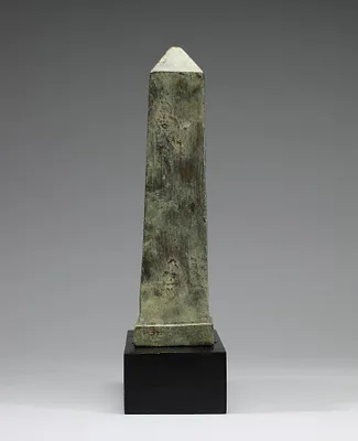 Figure of a Lion-Headed Goddess in Front of an Obelisk