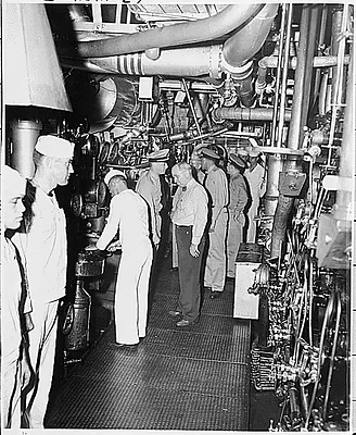 Commander N. V. King shows President Harry S. Truman the engineering room of the U. S. S. Augusta as the President tours the ship that will take him to the Potsdam Conference in Germany.