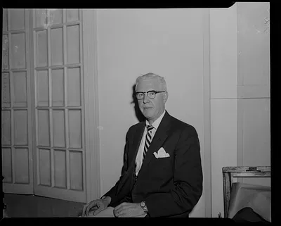 Man with glasses, seated